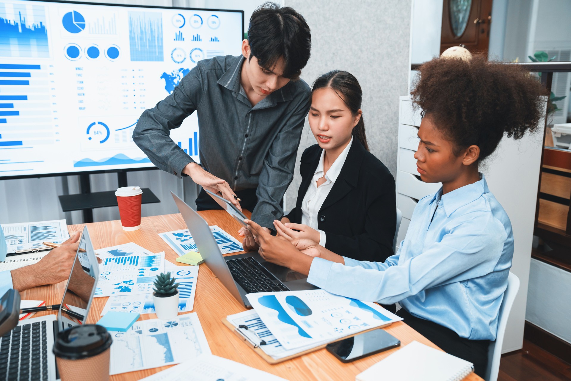 Multiracial analyst team use BI dashboard for data analysis with laptop. Concord
